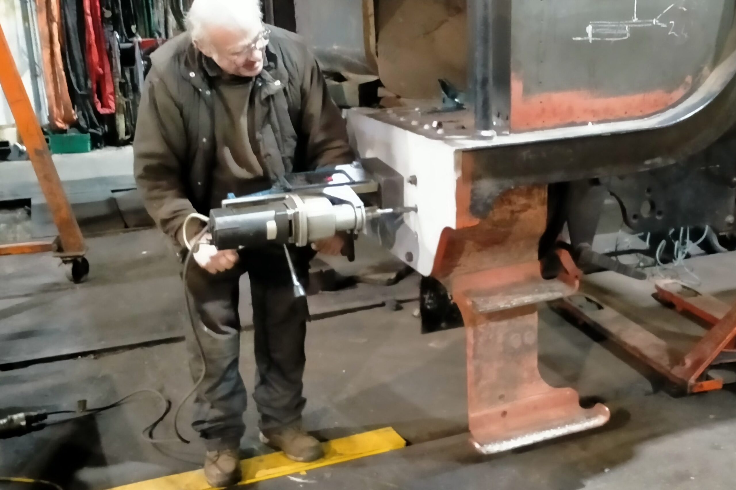 Barry reaming the rivet holes for the cab steps in the new drag box buffer beam.