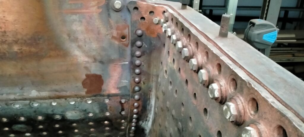 The first of the cover lap seams riveted.